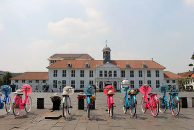 People on street against buildings in city