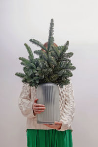 Rear view of woman standing against white background