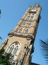 Low angle view of bell tower against blue sky