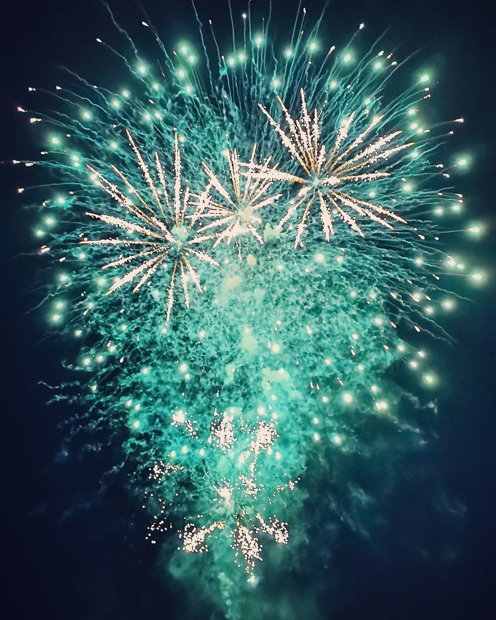 LOW ANGLE VIEW OF FIREWORKS IN SKY