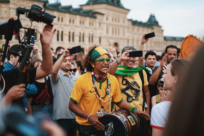 People photographing on street in city