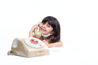 Portrait of a smiling girl over white background