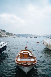 Boats moored in sea against sky