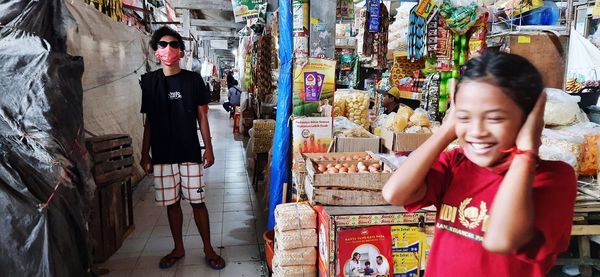 Full length of woman standing at market stall