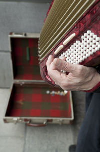 Midsection of man playing musical instrument