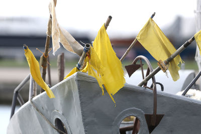 Close-up of yellow flags against sky