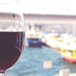 Close-up of beer glass against sea