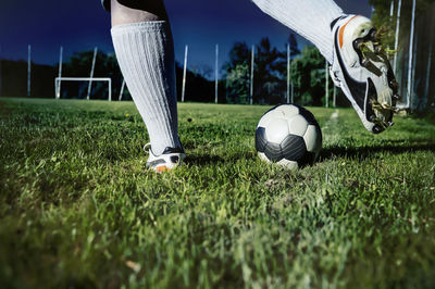 Low section of soccer ball on grass