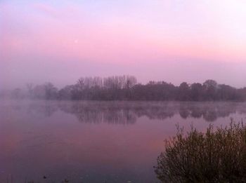 Scenic view of calm lake at sunset