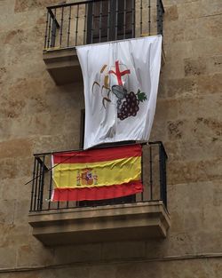 Low angle view of flags hanging on balcony