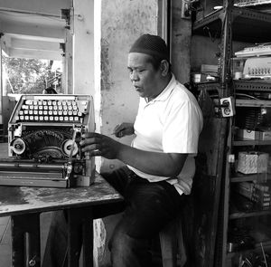 Man repairing typewriter