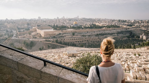 Rear view of man looking at cityscape