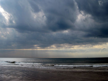 Scenic view of sea against cloudy sky