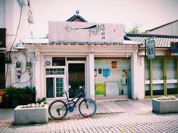 Bicycle outside house against building