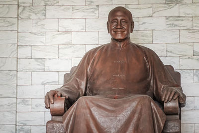 Portrait of buddha statue against wall
