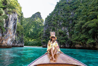 Portrait of woman in sea against trees