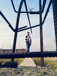 Young boy portrait from metal rods