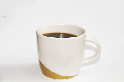 Close-up of coffee cup against white background