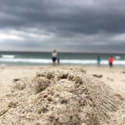 Rocks on beach against sky