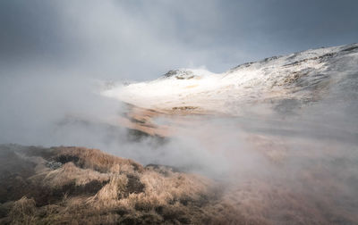 Scenic view of volcanic mountain against sky