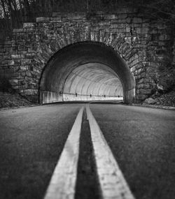 Empty road leading towards tunnel