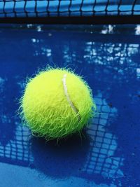 Close-up of tennis ball on wet street