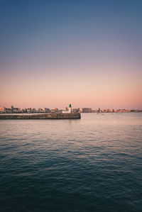 Scenic view of sea against clear sky during sunset