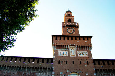 Low angle view of clock tower against clear sky