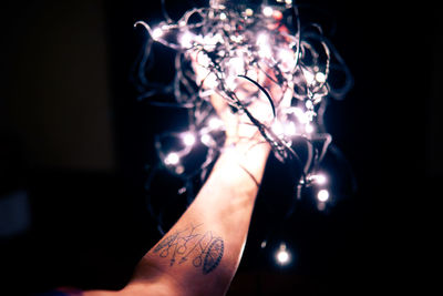 Close-up of hand holding illuminated light