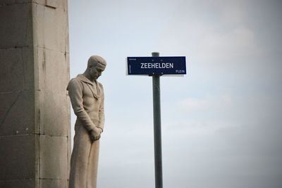 Low angle view of man standing against sky