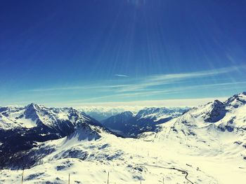 Scenic view of snow covered mountains against sky