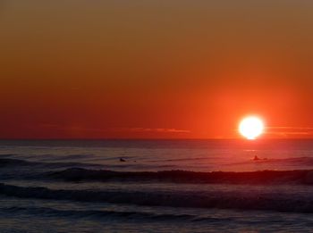 Scenic view of sea against orange sky