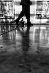 Low section of people walking on tiled floor