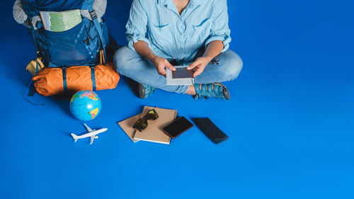 High angle view of man with toy against blue background