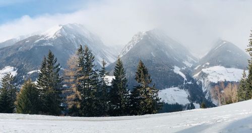 Scenic view of snow covered mountains against sky