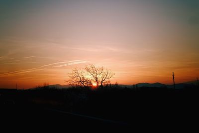 Silhouette landscape against sky during sunset