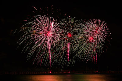 Low angle view of firework display at night