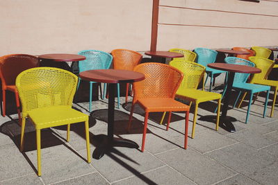 Empty tables and chairs at outdoor cafe