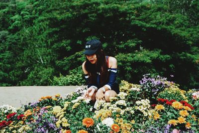 Woman sitting on flowering plant