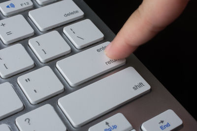 Close-up of hand typing computer keyboard