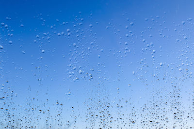 Full frame shot of wet glass window