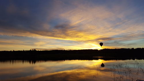 Scenic shot of calm lake at sunset