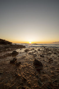 Scenic view of sea against clear sky during sunset