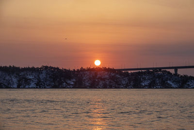 Scenic view of silhouette trees against orange sky