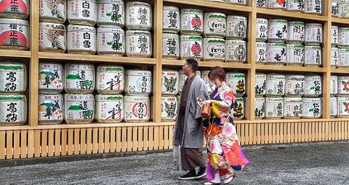 Full length of woman standing against graffiti