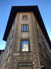 Low angle view of building against clear blue sky