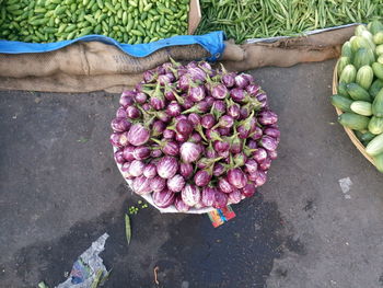 High angle view of eggplants in basket at market for sale