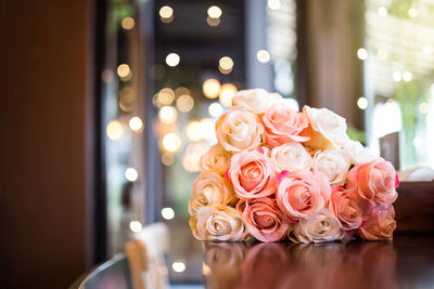 Close-up of pink rose on table
