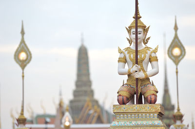 Statue against temple