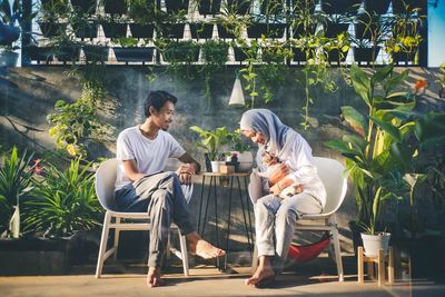 Couple sitting on chair at table